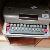 A vintage Aristocrat portable typewriter in metal case