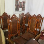 A set of 6 dining chairs with tooled leather seats and backs