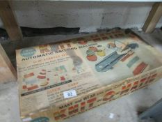 A boxed vintage 'Knitomatic' child's knitting machine