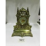 An ornate brass mantel clock