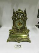 An ornate brass mantel clock