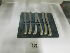 A set of 6 silver handled butter knives (hallmarks are worn)