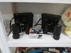 2 cased pairs of binoculars and a smaller pair