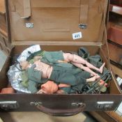 An old leather case containing Action man dolls and various clothing
