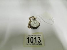 A ladies fob watch with 15ct gold chain,
