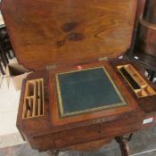 A Victorian walnut inlaid writing table with fitted interior