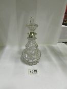 A 19th century cut glass with white metal top liquor decanter