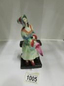 A Tuscan china figurine 'April Showers' (has chip on end of umbrella)