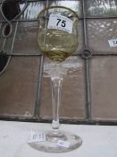 An amber glass wine goblet on decorative stem