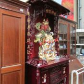 A Chinese lacquered  and inlaid cabinet together with a large Chinese Diety figure