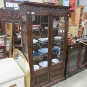 A priory style oak leaded glazed cabinet