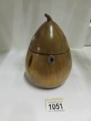 A wooden tea caddy in the shape of a pear