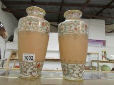 A pair of vases marked H & S L Oriental