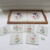 A pair of framed floral tiles and 6 small tiles decorated with flowers and insects