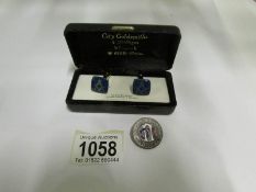 A pair of Masonic cuff links and a badge