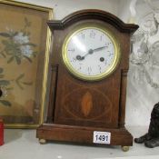 A Victorian inlaid mantel clock