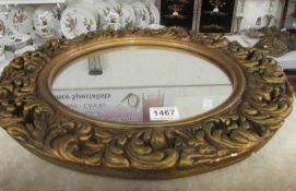 A circular gilt framed mirror