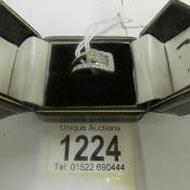 A diamond ring fashioned as a buckle in 18ct white gold, estimated diamond weight 0.