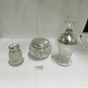 3 items of glass with silver tops