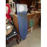 A retro ironing board with seat