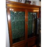 An Edwardian mahogany display cabinet with lead glazed doors