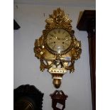 An ornate gilded wall clock