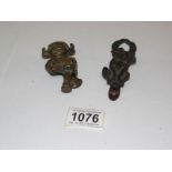 2 brass doorknockers being a Lincoln Imp and a Bonzo type dog