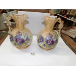 A pair of Austrian hand painted ewers