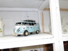 A tin model of a Volkswagen camper van