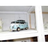 A tin model of a Volkswagen camper van