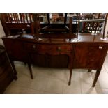 A mahogany inlaid bow front sideboard on tapered legs