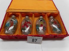 A cased set of 4 Chinese Hand painted scent bottles