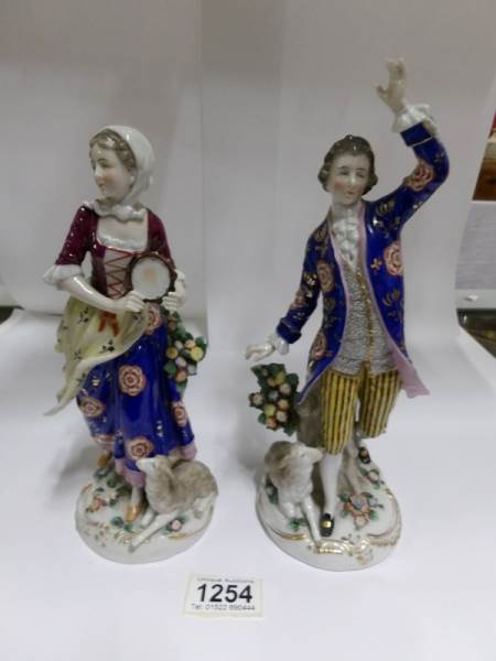 A pair of Chelsea figures with gold anchor mark,