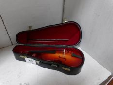 A miniature violin in case