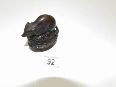 A bronze mouse on a nut