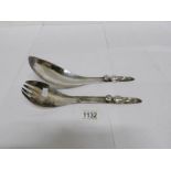 An unusual pair of unmarked salad servers with alien figures on handles (possibly continental