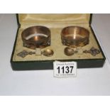 A cased pair of salts and spoons,