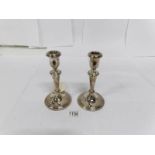 A pair of silver candlesticks with Sheffield hall mark,