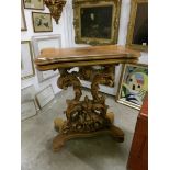 A carved and gilded hall table with rotating top