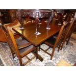 An oak refectory table and set of 6 oak dining chairs