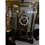 A glass cased skeleton clock