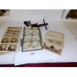 A Victorian viewer with a selection of cards depicting the Boar War in South Africa,