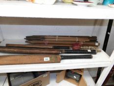 A set of wickets and vintage cricket bats