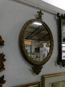 A Victorian oval gilt framed mirror,
