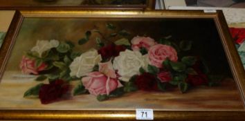 A framed oil on canvas of roses, image 60 x 30cm,