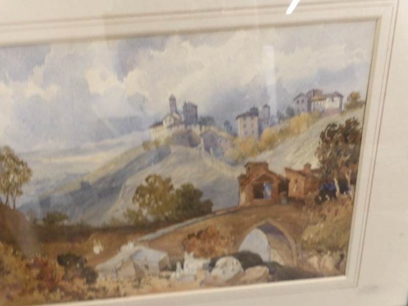 A framed and glazed watercolour, castle on mountain top with uncompleted figures in the foreground, - Image 2 of 2