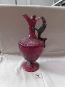An early cranberry glass ewer with blue enamel mottled decoration and dragon handle (handle a/f)