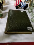 A Victorian leather bound photograph album with photos