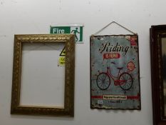 A vintage style metal bike sign and a picture frame