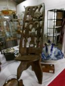 An East African carved hardwood birthing chair from the Congo.
